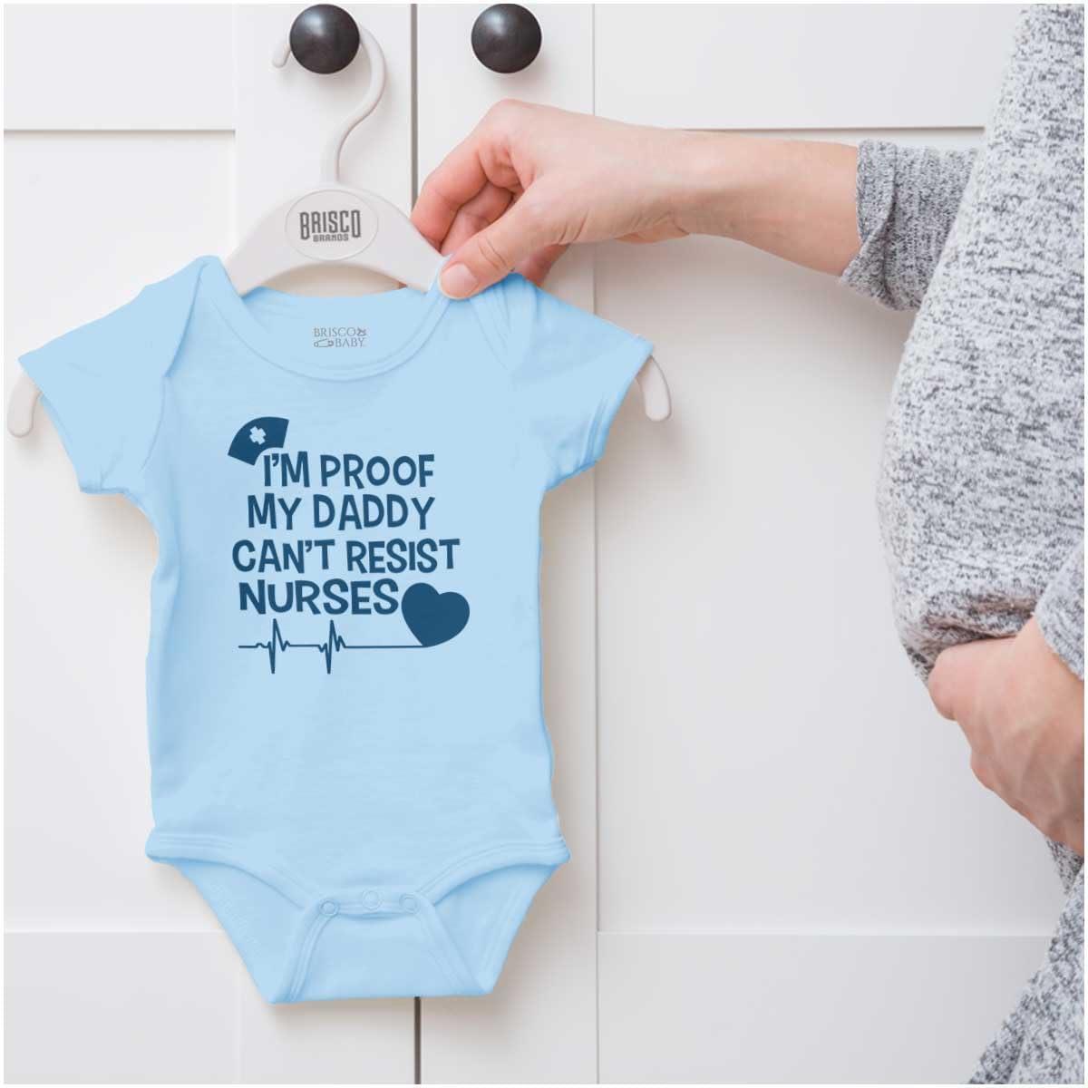 imageBrisco Brands Proof Daddy Cant Resist Nurses Heart Baby Romper Boys or GirlsLight Blue